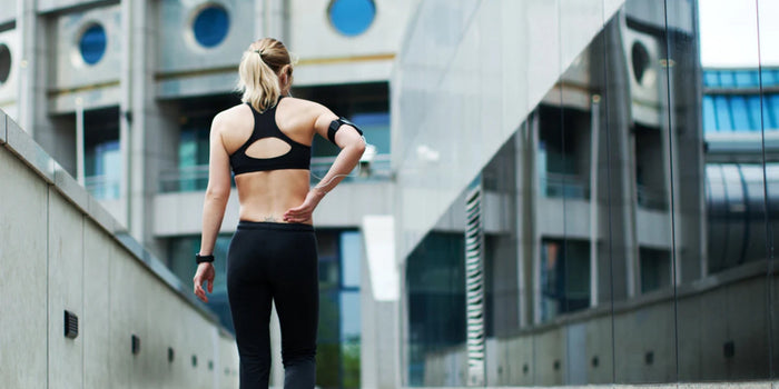 a person in exercise gear walking towards a building