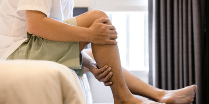 a person holding their leg due to a cramp