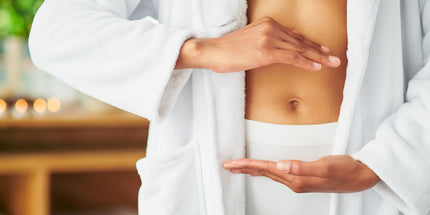 a person in a white robe, making a shape with their hands