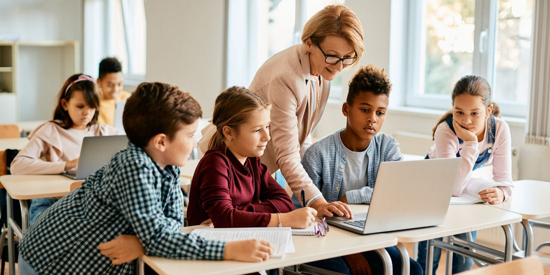 Students in a classroom with teacher assistance