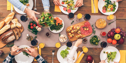 a table of food with people gathered around