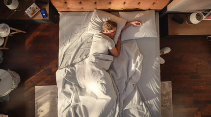 A man sleeping peacefully in bed, illustrating how sleep quality affects overall health in an article about five surprising ways poor sleep impacts the body.
