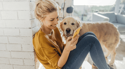 Woman reading ways to reset stress setting with her pet dog