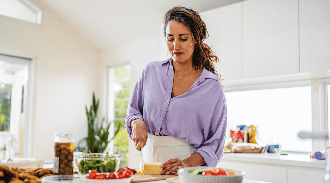 Woman in her later 40s preparing a healthy meal in the kitchen