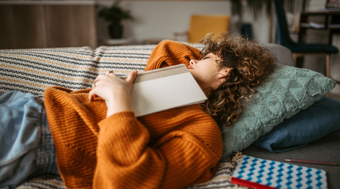 Woman laying exhausted on the couch