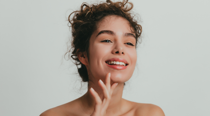 Curly-haired beautiful woman smiling in the mirror