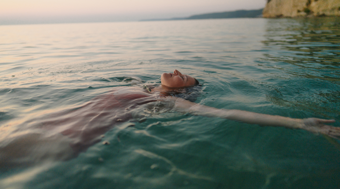 Carefree Woman Floating in the Ocean