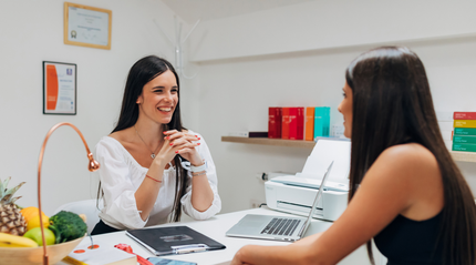 Woman speaking with female dietitian