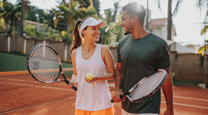 Two tennis partners standing together