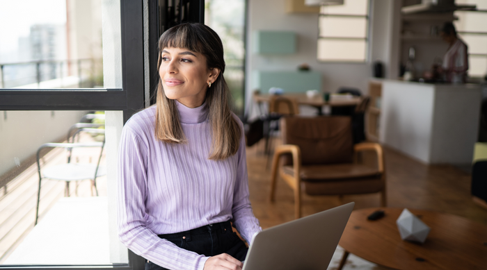 Woman researching on a laptop in a cafe 