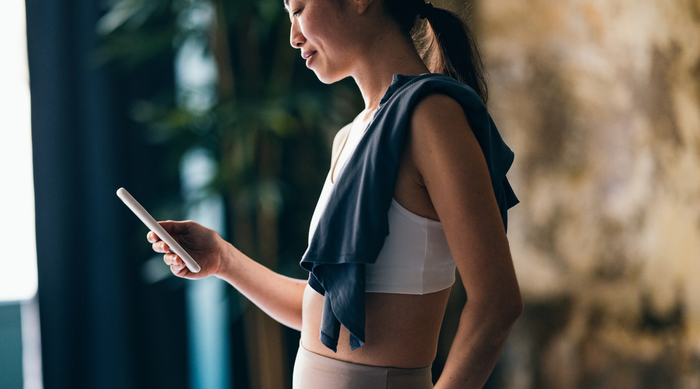 Woman checking phone wearing active wear