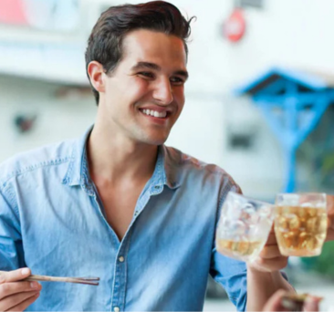 Two individuals toasting their drinks, creating a sense of celebration