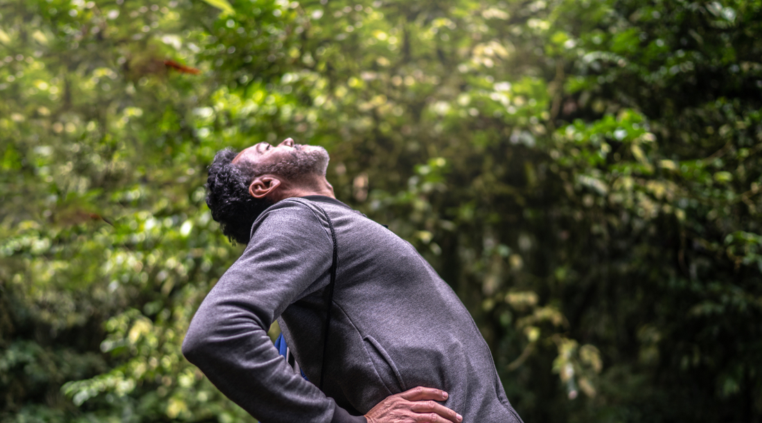 Man stretching his back to relieve pain
