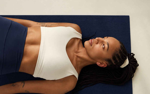 Woman lying on a yoga mat 