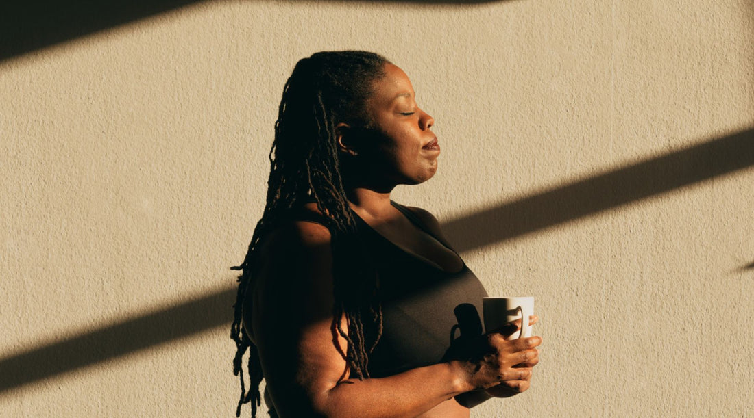 Woman standing and facing the sunlight on her body.