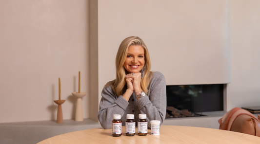Rebecca Maddern smiling with Metagenics products in front