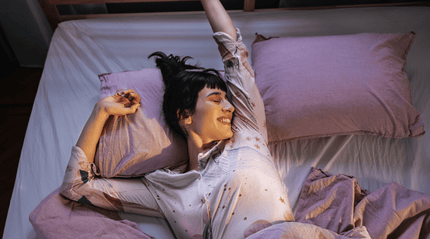 Woman waking up well rested in bed