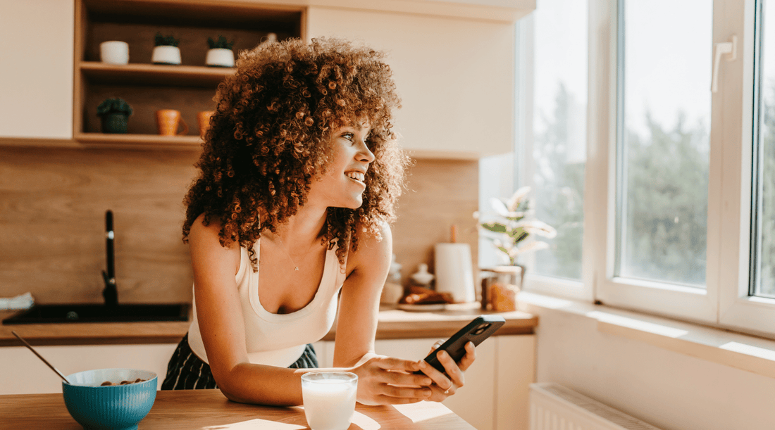 The 5 Best Magnesium Supplements:Woman leaning on bench in warm-lit kitchen